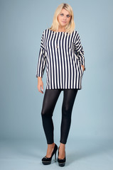 Beautiful young girl  posing on a blue background