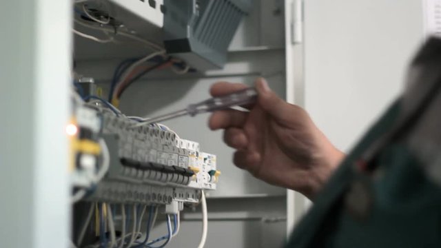 Relays of voltage control. Control print electrician. Voltage indicator. Verification circuitry. Electricians checks the voltage by controlling the relay.