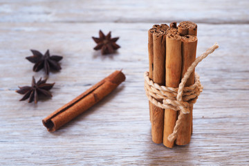 Close up of bundle cinnamon sticks on a wooden background.