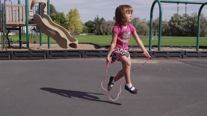 Little girl skipping rope at pre-school - 4K - Powered by Adobe