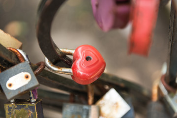 Padlock in combination with ropes, threads and scraps of fabric.