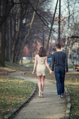 Obraz premium Young, happy and attractive couple enjoying together in walk through the city park. Urban outdoors.