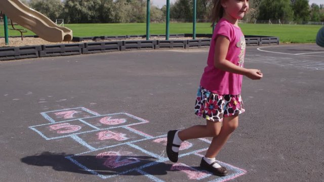 Little girl playing hopscotch at pre-school - 4K