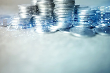 Double exposure of city and rows of coins for finance and banking concept

