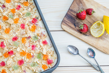 Homemade No-Bake Cheesecake with Strawberries, Marmalade and Cookies in Baking Dish for Birthday Party, Top View
