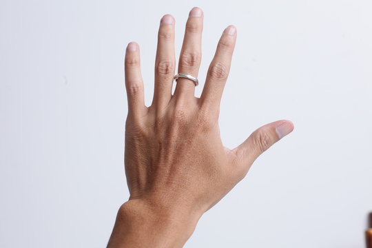 Close Up Hand With Silver Ring Isolated On White Background