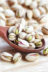 Pistachios in a wooden spoon. Selective focus