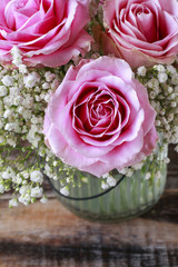 Bouquet of roses on wooden background.