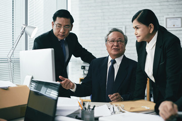 Experienced Asian team talking about legal case