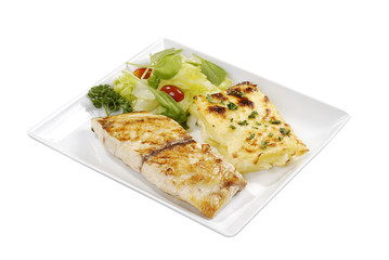 Grilled fish and potato on white dish isolated on background.
