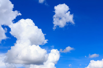 Obraz premium Blue sky background with white clouds and rain clouds. The vast blue sky and clouds sky on sunny day. White fluffy clouds in the blue sky.