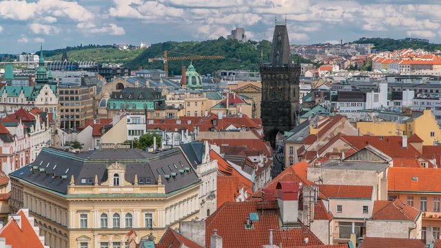 Aerial view of the traditional red roofs of the city of Prague, Czech Republic with the Powder tower and Vitkov Hill in the distance timelapse.