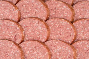 Salami background with many sliced pieces of salami