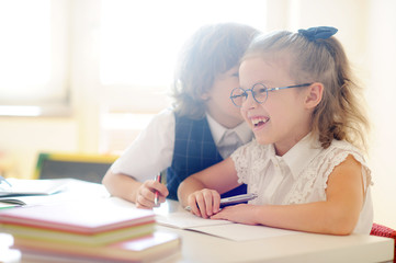 Fototapeta premium Small schoolcilds do a homework.