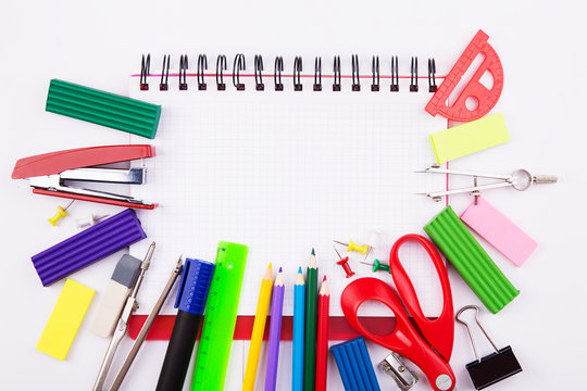 Various office supplies with blank notebook and space for the text on a white background. Back to school.