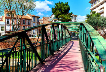 Footbridge across the city canal in the Perpignan city. France