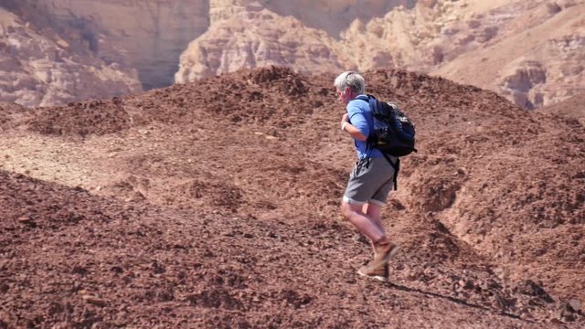 The journey to the desert. Lone climber explores Sodom and Gomorrah.Long pan shot
