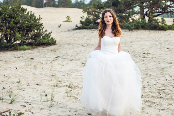 Fototapeta na wymiar Romantic beautiful bride in white dress