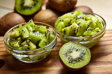 Naklejka na ściany i meble Healthy food. Tropical fruit. Whole and sliced kiwi. Kiwi fruit. Still life. Juicy kiwi on the wooden table