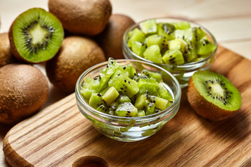 Healthy food. Tropical fruit. Whole and sliced kiwi. Kiwi fruit. Still life. Juicy kiwi on the wooden table