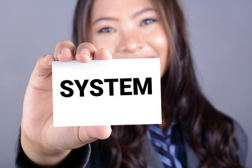 SYSTEM word on the card shown by a businesswoman