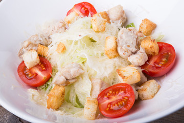 Caesar salad in a white bowl