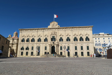 Fototapeta na wymiar Valletta, Malta - August 02 2016: Facade with Malta flag of Auberge de Castille. This historic two-storey building in Baroque style, is the Office of the Prime Minister of Malta.