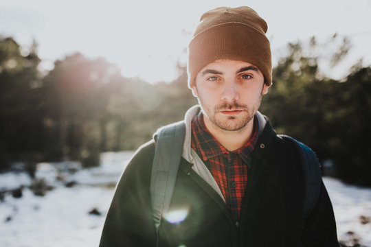Portrait of young backpacker in winter forest