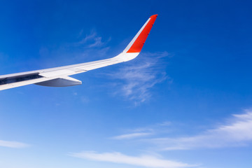 Fototapeta premium View from airplane window with blue sky and white clouds
