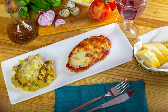 Chicken Parmigiana And Spaghetti Close Up On A Plate On The Table.