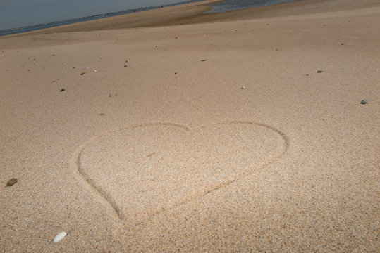 Heart on the beach drawing on the sand
