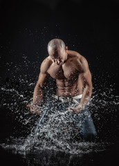  athletic man striking with a hand on water