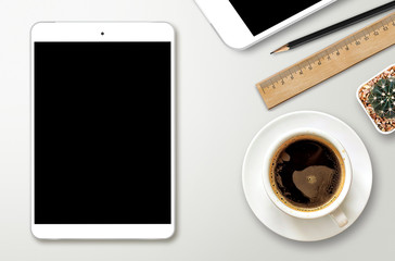 workplace with blank screen smartphone, tablet, coffee cup, pape