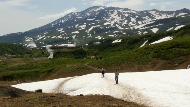 Tourists walking in mutnovsky volcano area kamchatka russia