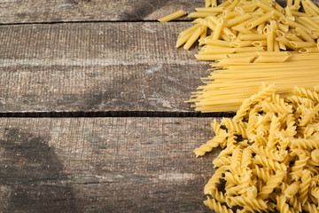 Mixed pasta . On a wooden background. Top view