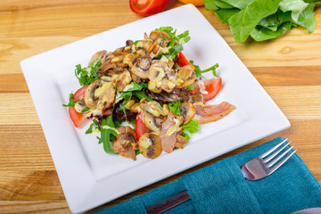 Warm mushroom salad with chilli and tomatoes