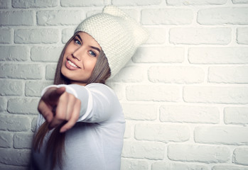 Portrait of young attractive cheerful hipster girl making funny