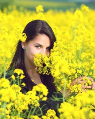 portrait of a beautiful girl in the colza field