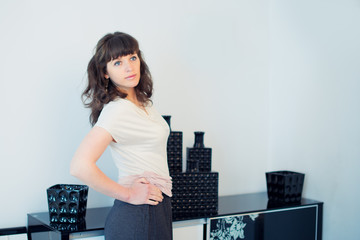 Portrait of young beautiful fashionable woman in the interior