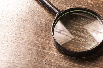magnifying glass on the  wooden background