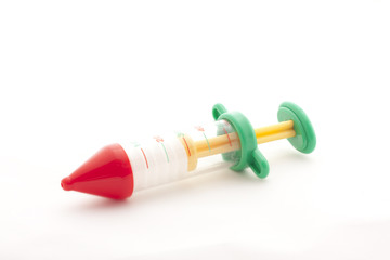 Toy syringe on white background