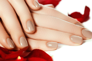 Perfect manicure. Woman hands with manicured natural beige nails . Beautiful female fingers with...