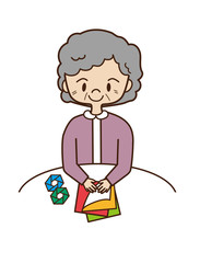 折り紙を折る高齢者