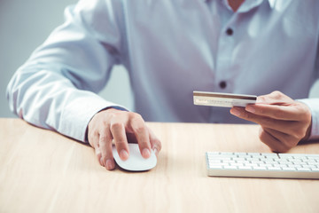 Fototapeta premium Hands holding plastic credit card and using laptop. Online shopp