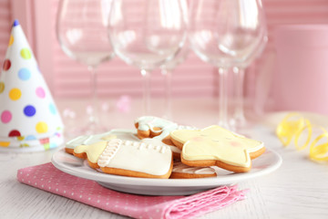Baby glazed cookies on decorated table