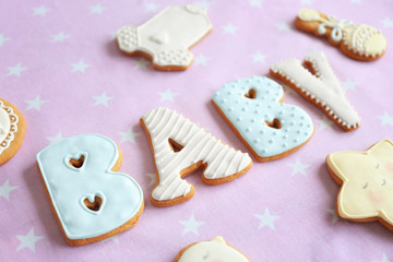 Fototapeta na wymiar Baby glazed cookies on decorated table