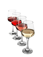 Glasses with different wine in a row, isolated on white