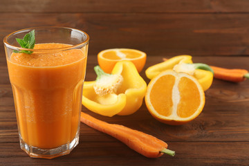 Tasty smoothie drink with vegetables and fruits on table