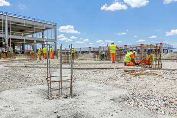 Construction workers binding rebar for reinforce concrete column