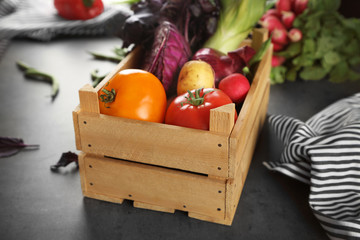 Fresh vegetables in wooden box on table